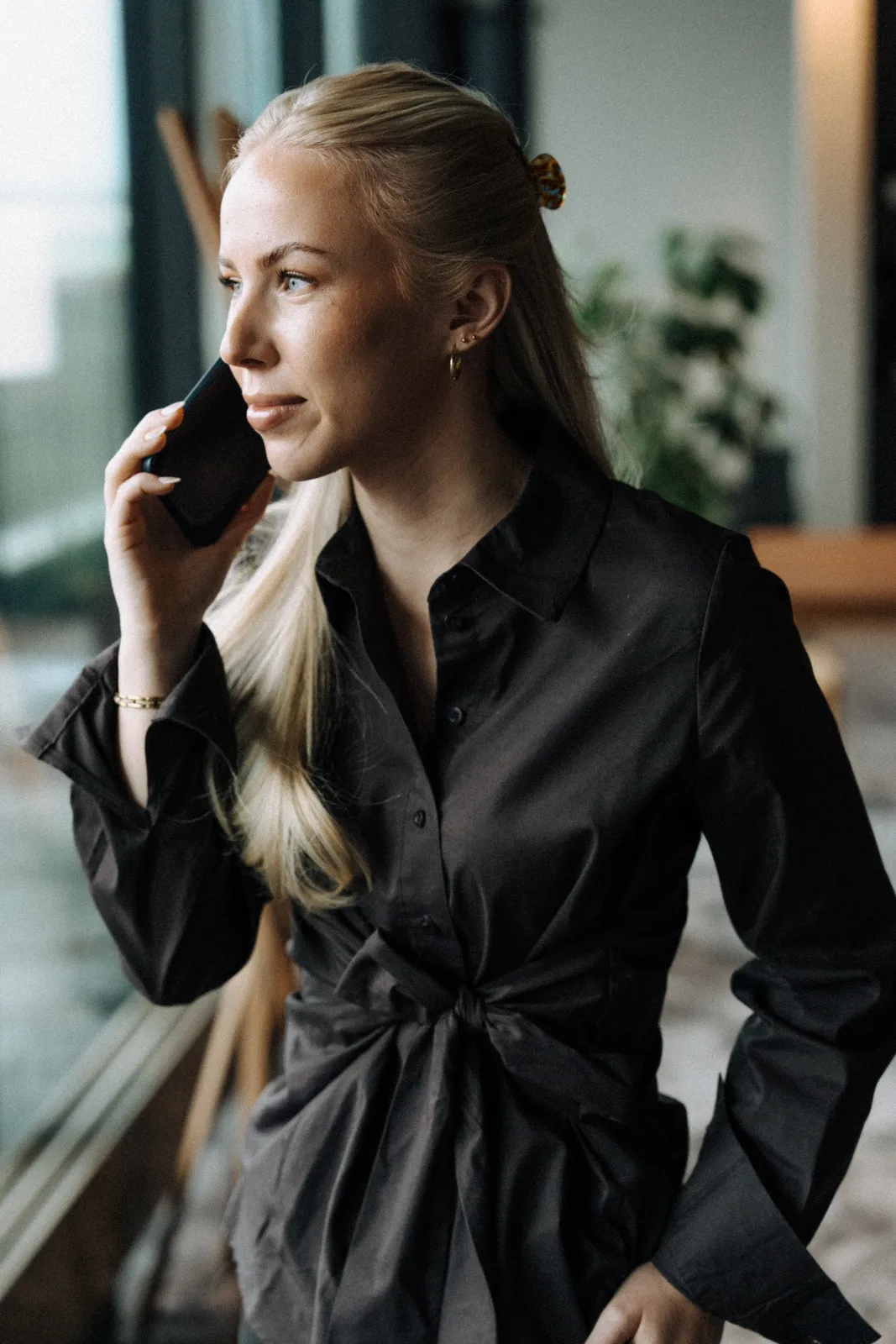 En från Maraton i telefon vid fönstret
